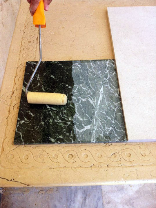 Application of professional colour intensifier on marble surface