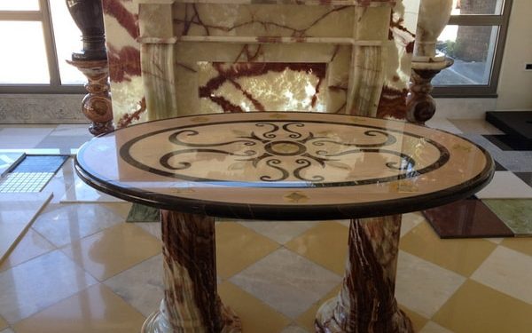 Waterjet table design from Portogalo, Nero Marquina and Onyx and fireplace from Onyx